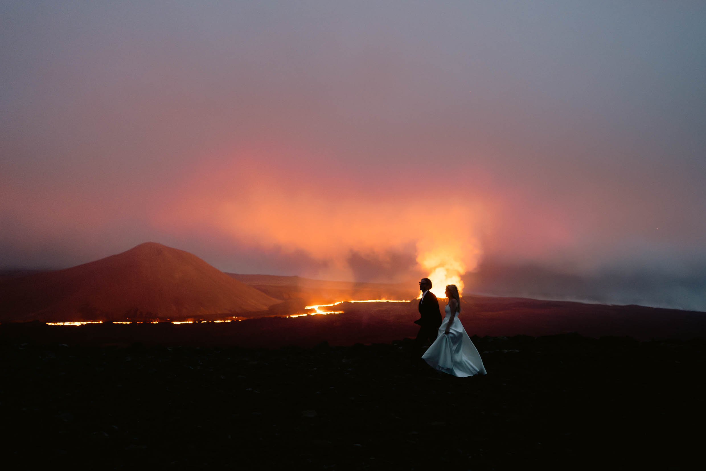 Photoshooting of a couple in front of an active volcano Photoshooting of a couple in front of an active volcano